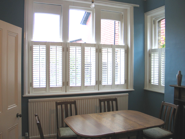 Cafe height shutters white wood with 47mm louvres installed by Select Shutters in North London