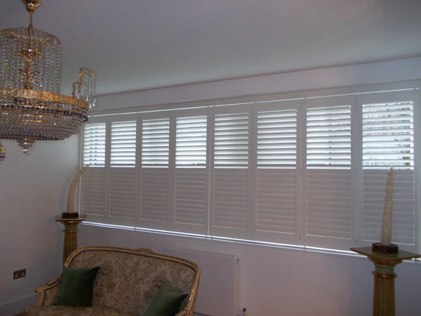 Wooden Plantation Shutters with track for wide window in Central London installed by Select Shutters