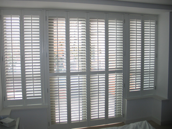 Silk white wooden plantation shutters with 63mm louvres